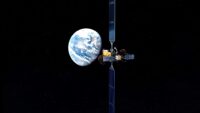 Illustration: Starfish Space Otter space vehicle in orbit with Earth's full disk in background